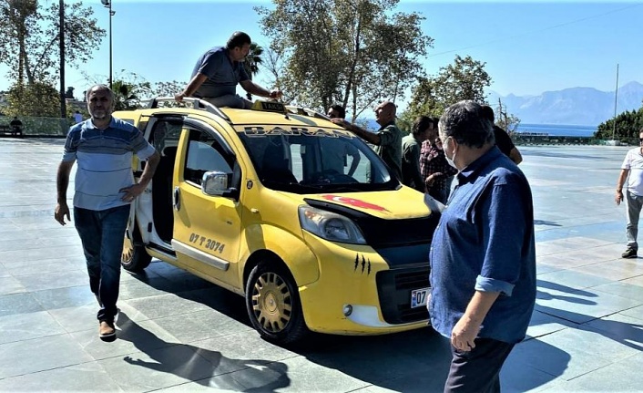 Ceza yazılacağını öğrenen ticari taksi sürücüsü aracının üzerine çıktı